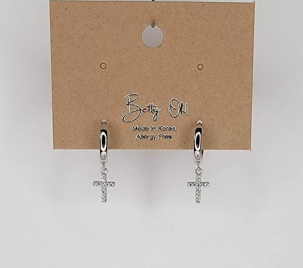 CROSS HUGGIE HOOP EARRINGS.: Silver