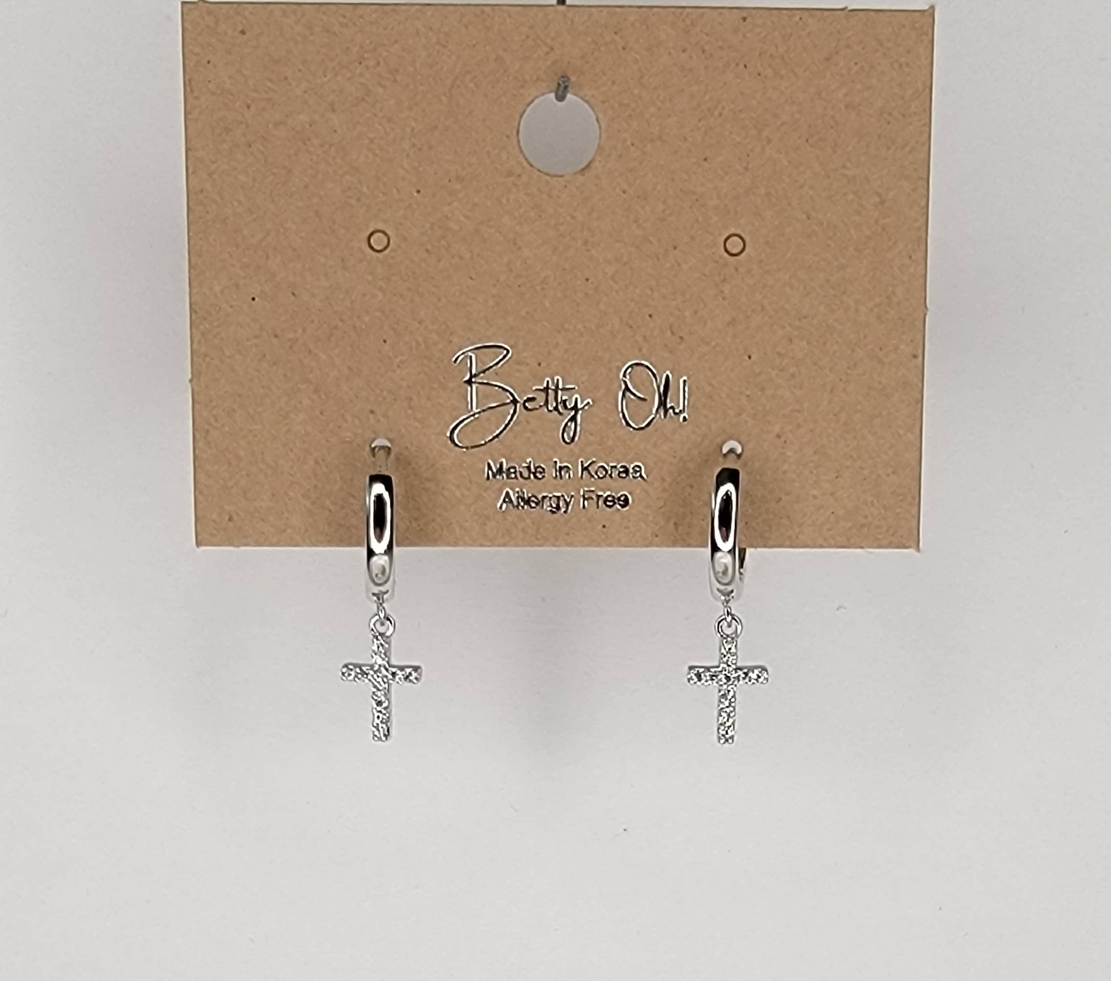 CROSS HUGGIE HOOP EARRINGS.: Silver