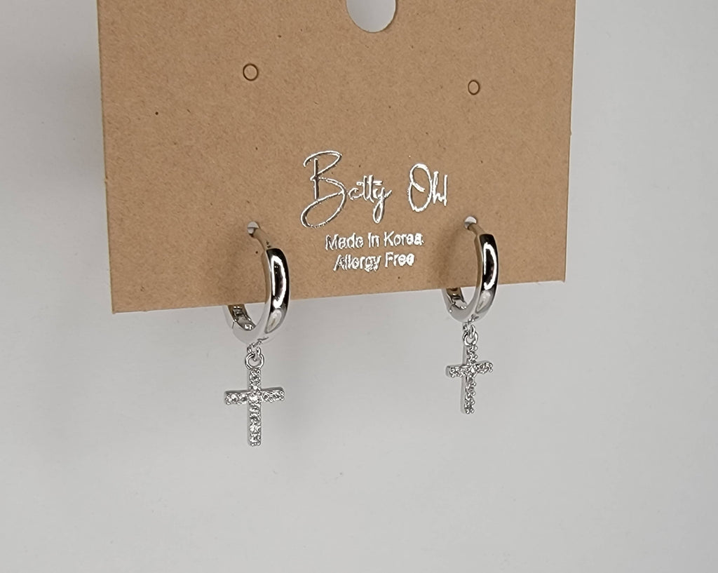 CROSS HUGGIE HOOP EARRINGS.: Silver